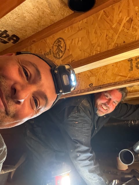 Prevail Plumbing team members working together on a job site